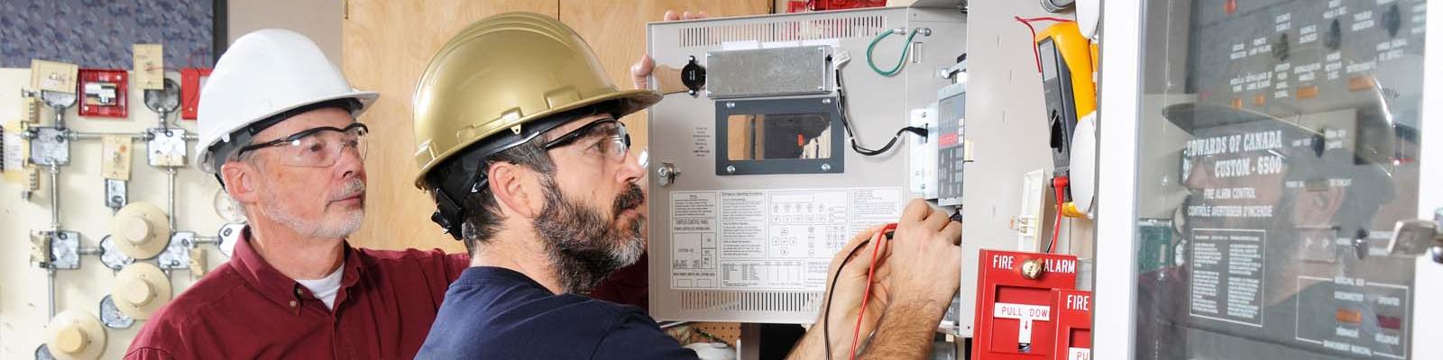Apprentice electrician being mentored by a journeyman electrician 